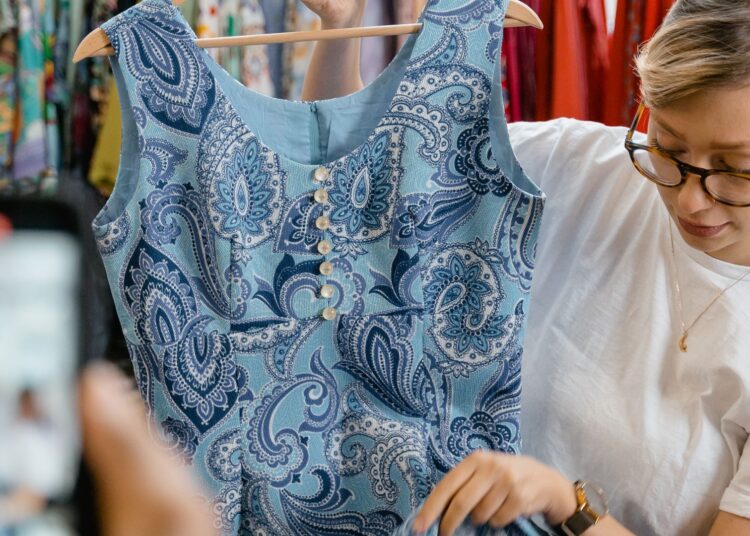 Persona preparando ropa de segunda mano para vender en Vinted y Wallapop desde el móvil