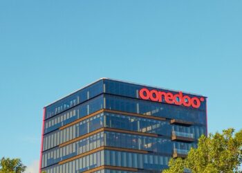 Edificio de oficinas acristalado que representa la inversión en SOCIMI desde España