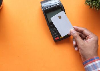 Persona pagando con una tarjeta prepago en un datáfono contactless
